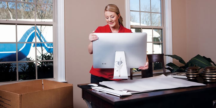 Woman packing her computer on desk